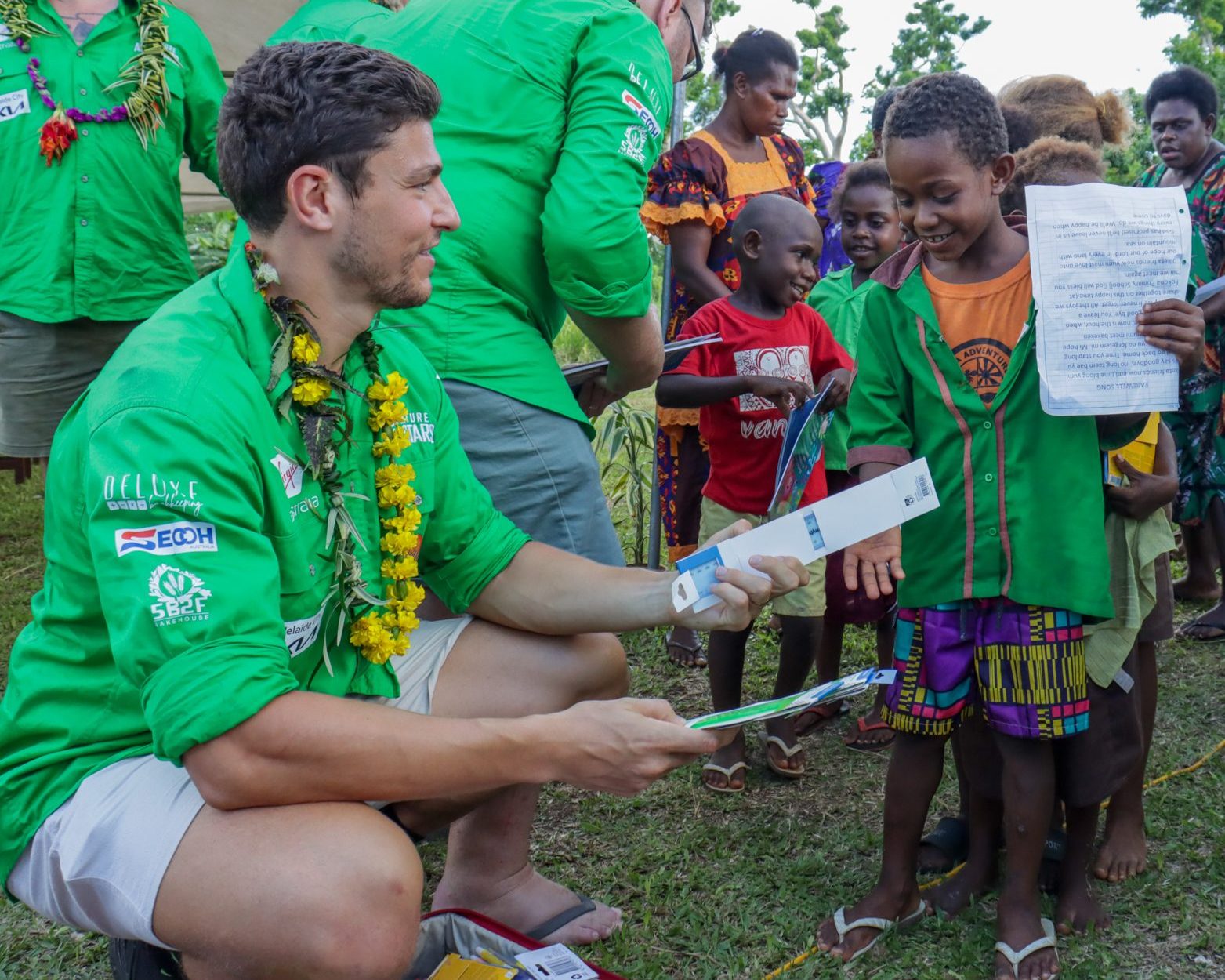 Corey Micari handing out donations to kids at cyclone ravaged school in Vanuatu during a charity trip.